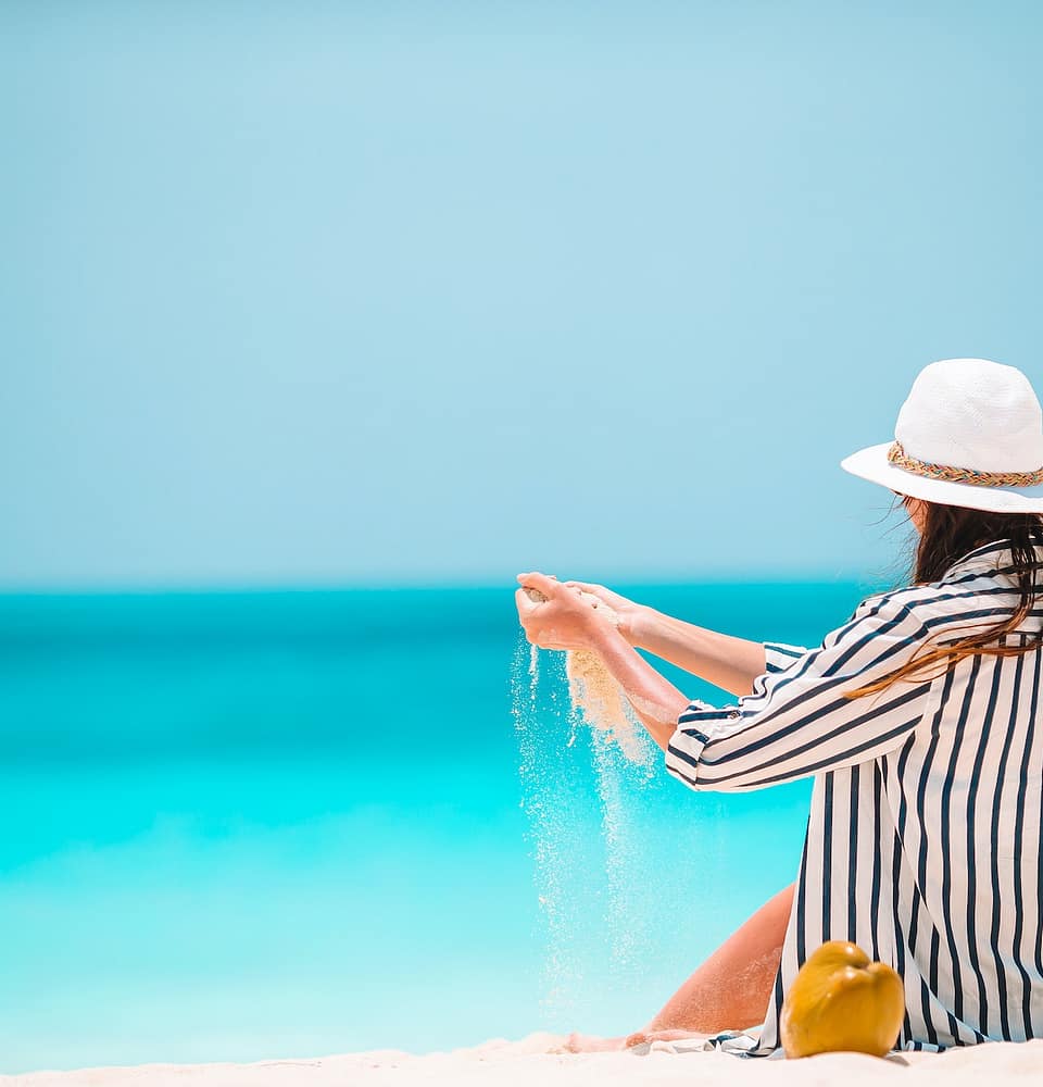 Young beautiful woman on beach vacation on Caribs